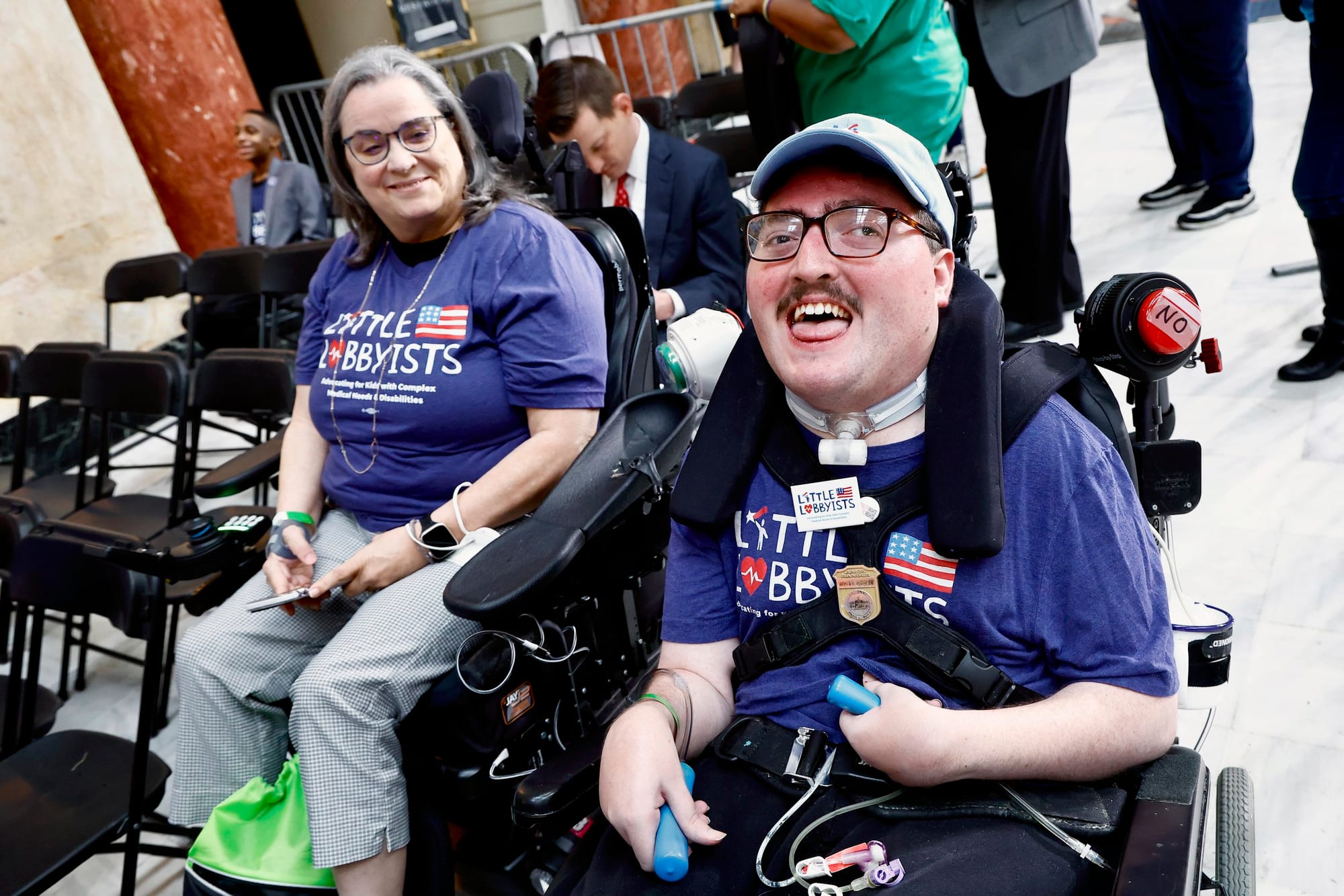 Stephanie and Rob pose in their wheelchairs inside the ADA section at the rally.