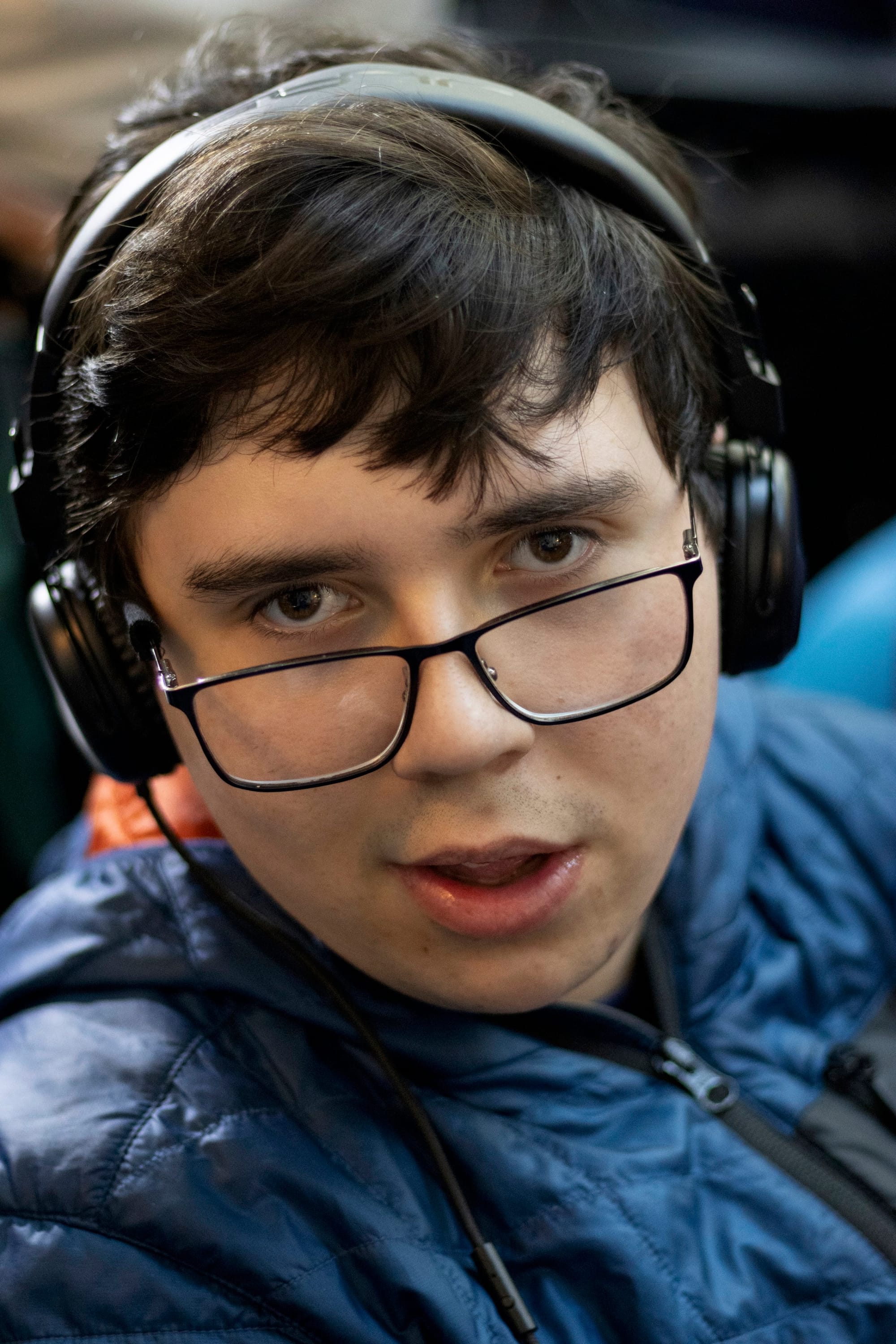 Simon, wearing his headphones and glasses, gives the camera a knowing and pensive look as he waits for the rally to begin.