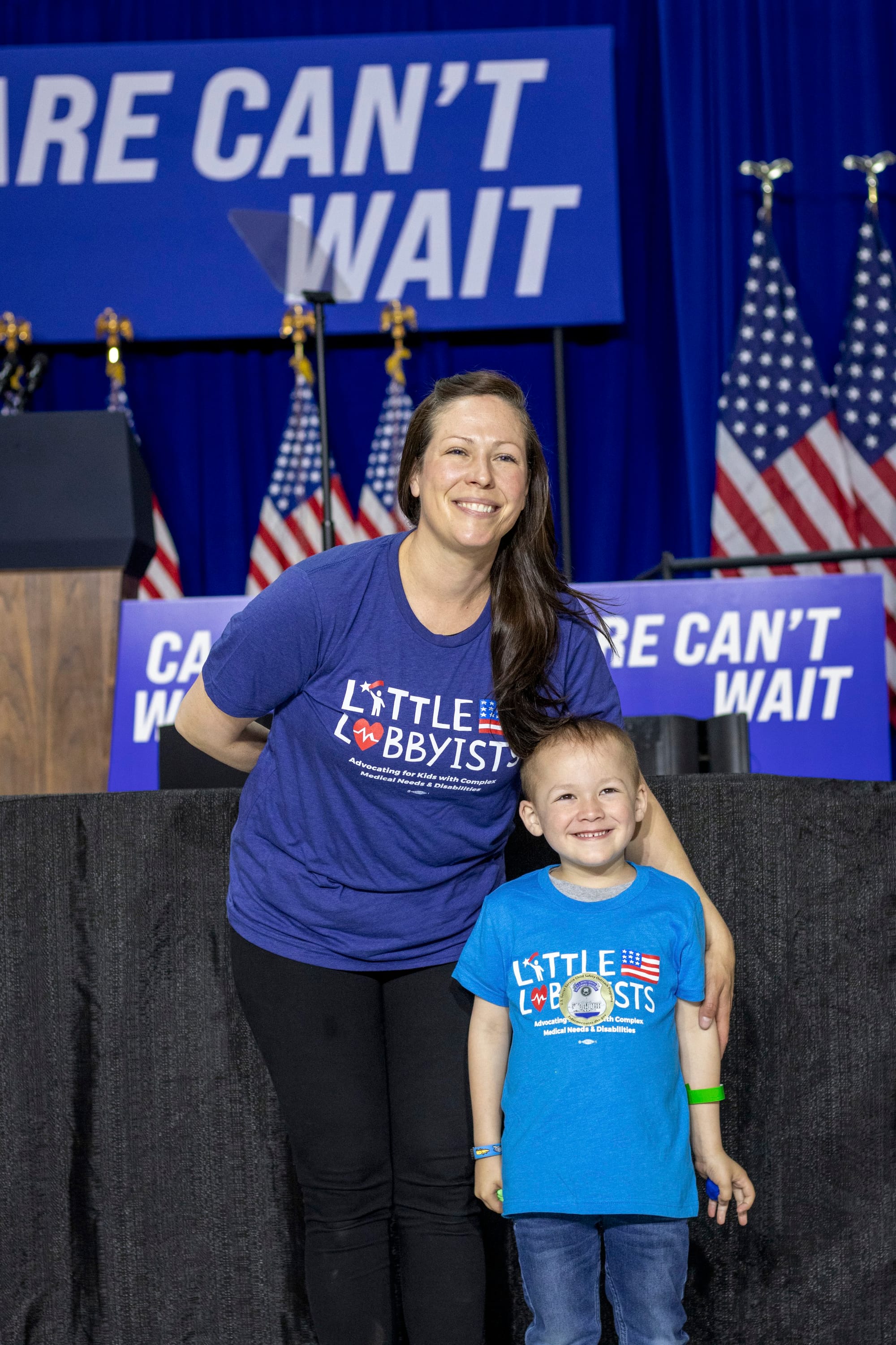 Megan and her young son Gabe pose in front of the stage.