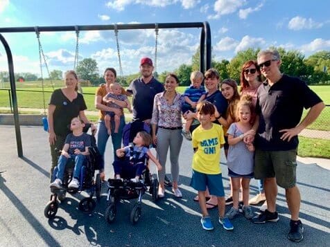 Little Lobbyists families pose on a playground after meeting with their representative.