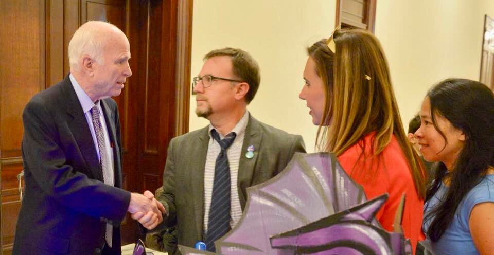A family shakes the hand of a senior member of the U.S. Senate.