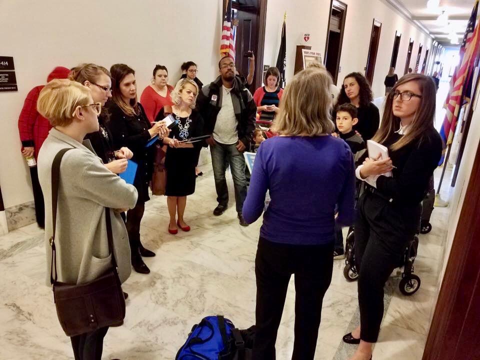 Little Lobbyists hold an impromptu meeting with a member of Congress in a marble-lined hallway.