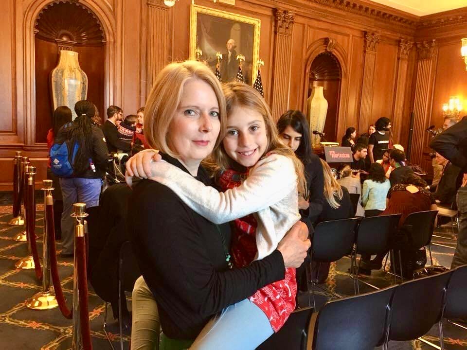 A mom and her daughter pose after a press conference in the U.S. Capitol.