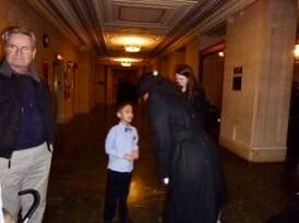 A young boy is photographed in the hallway of the Capitol.