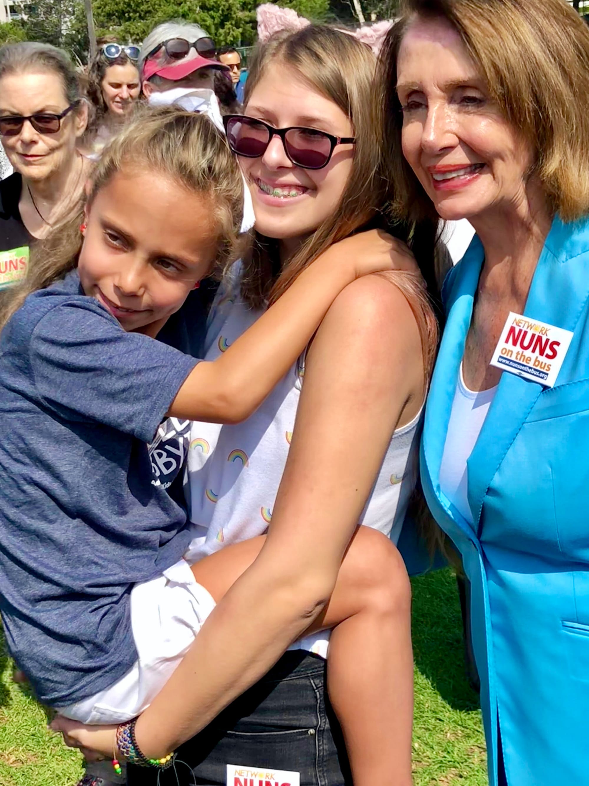 A Little Lobbyists mom holds her daughter while posing with the Speaker of the House.