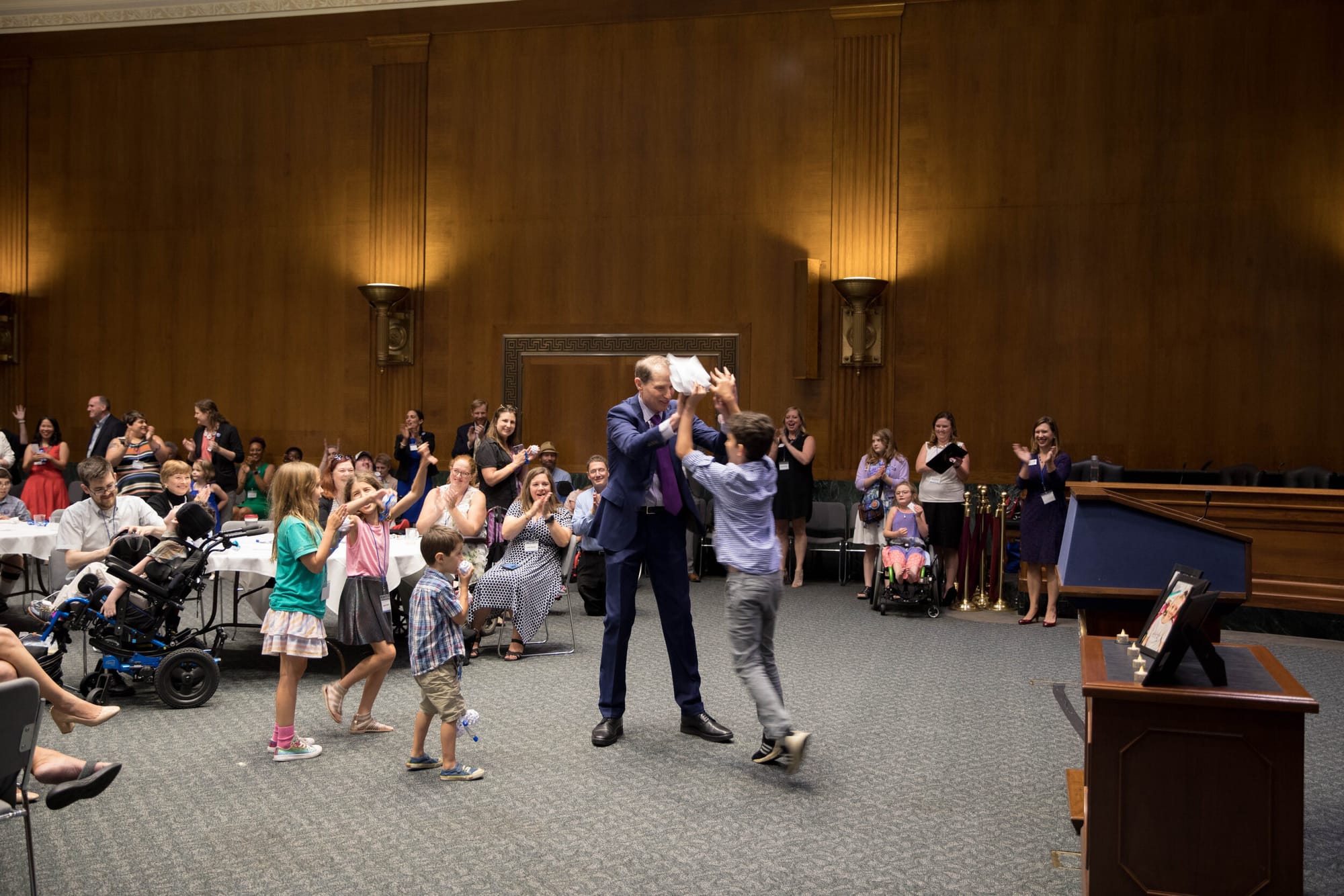 A Senator high fives a Little Lobbyists teen after his speech.