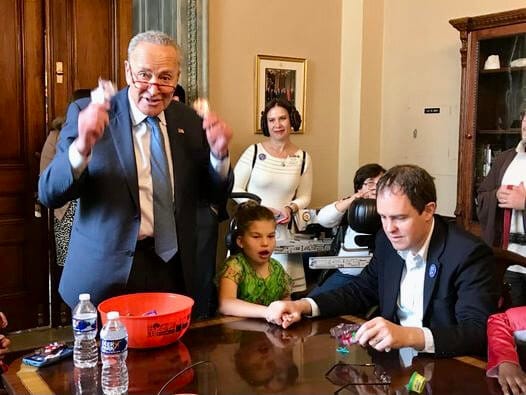 The then-U.S. Senate Minority Leader distributes Halloween candy to a group of children in his office.
