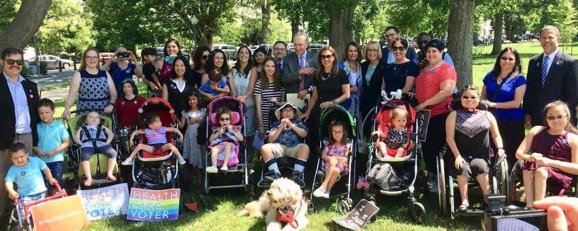 Little Lobbyists families and members of the House and Senate standing together on the Capitol lawn on a beautiful, sunny, summer morning.