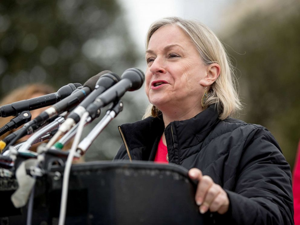 Susan Wild speaks outdoors at a podium