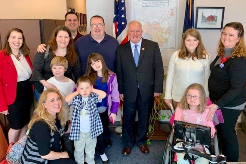 Mike Doyle standing (center) with several Little Lobbyists families in his local district office.