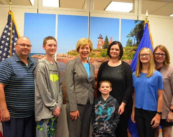 Aiden and his family and Allison and her family with Senator Tammy Baldwin.
