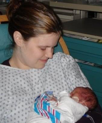 Kim cradling her infant son.