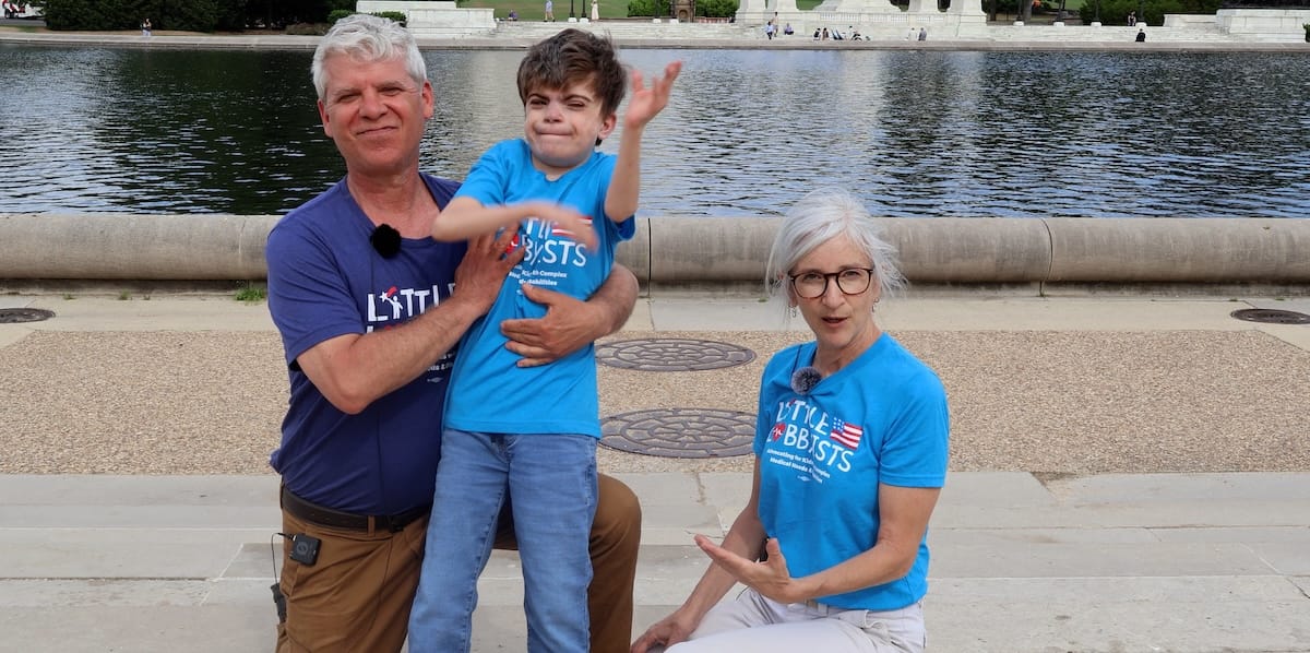 A smiling Charlie and his parents at the U.S. Capitol.