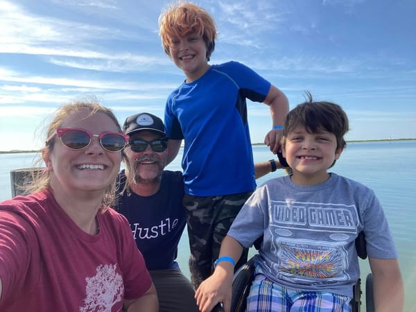 The Witzler family grins on a day at the beach.