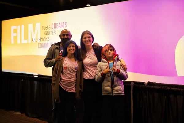 Alison and her family, all in Little Lobbyists shirts, smiling for the camera.